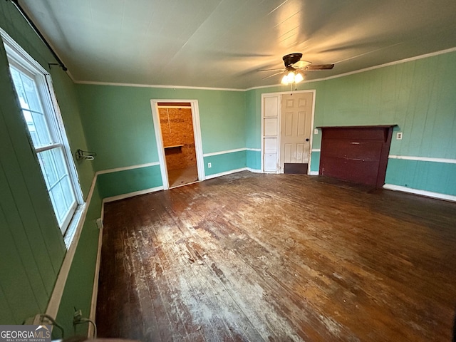 unfurnished bedroom with baseboards, wood-type flooring, ceiling fan, and crown molding