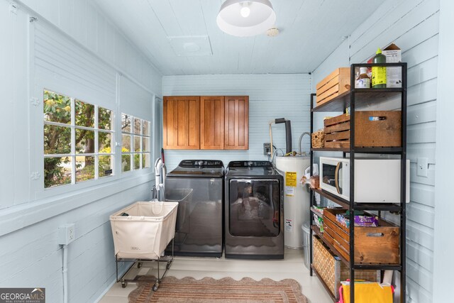 laundry room featuring cabinet space, water heater, and washing machine and clothes dryer