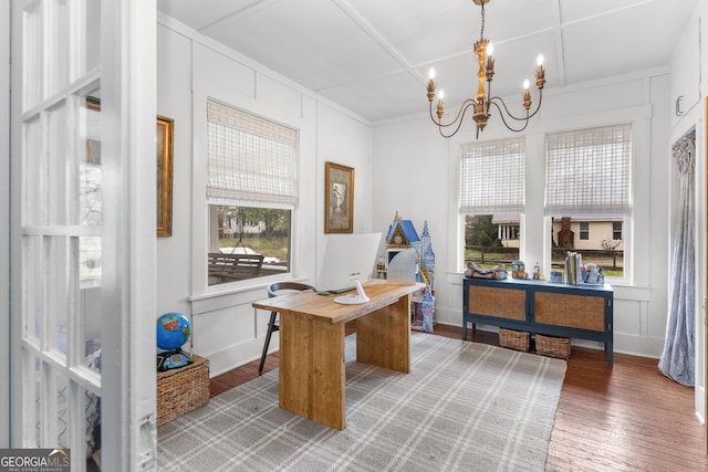 office area with a decorative wall, a notable chandelier, a healthy amount of sunlight, and light wood finished floors