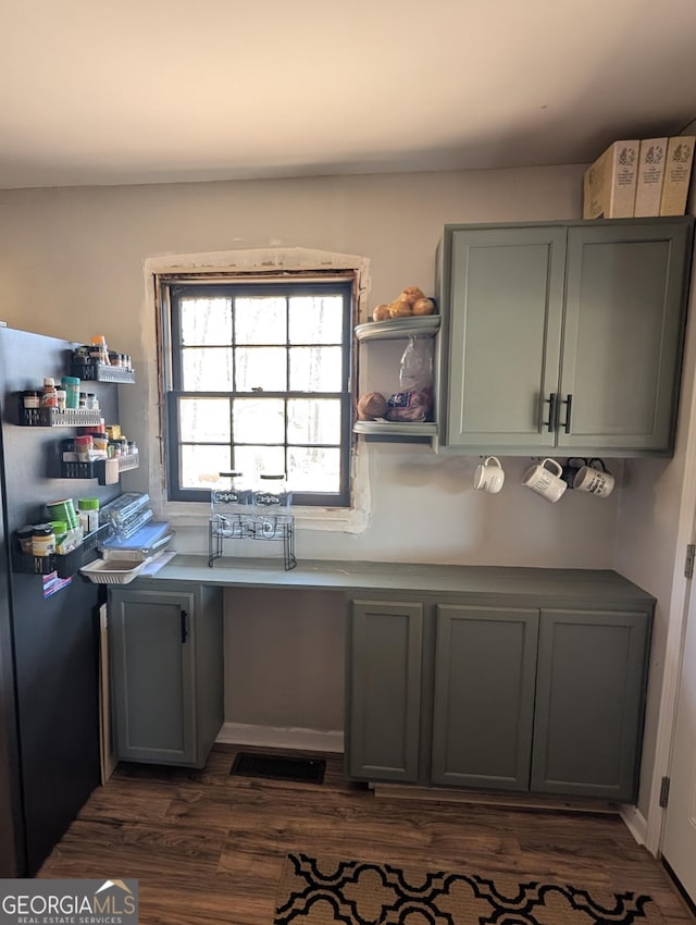 kitchen with dark wood-style floors, gray cabinetry, and open shelves