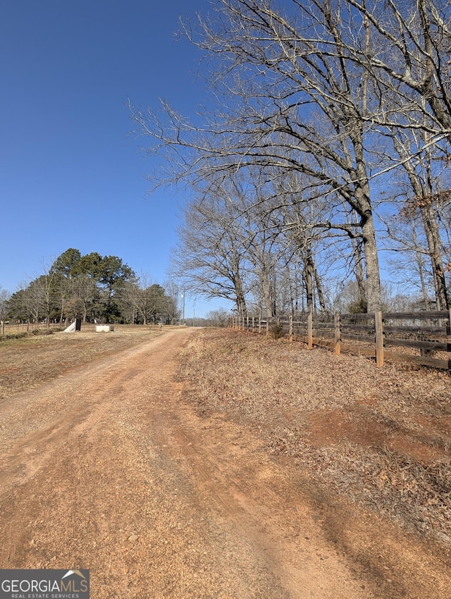 view of yard featuring a rural view and fence