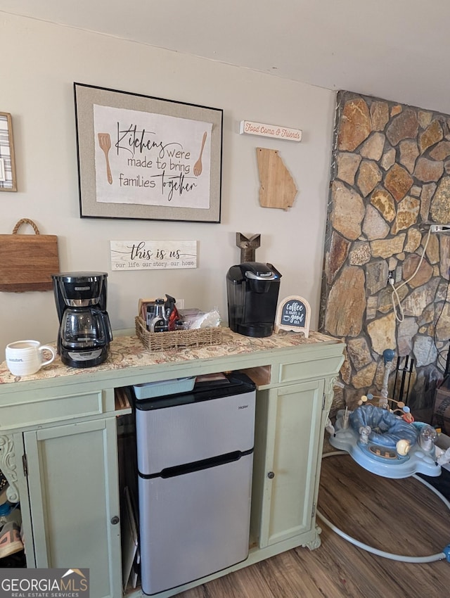 bar featuring freestanding refrigerator and wood finished floors