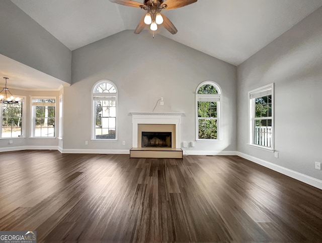 unfurnished living room with dark wood-type flooring, a fireplace with raised hearth, and baseboards