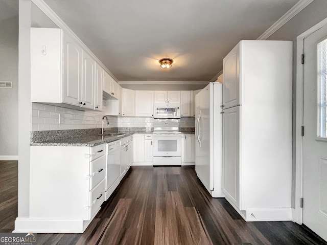 kitchen featuring a sink, light stone counters, dark wood finished floors, white appliances, and crown molding