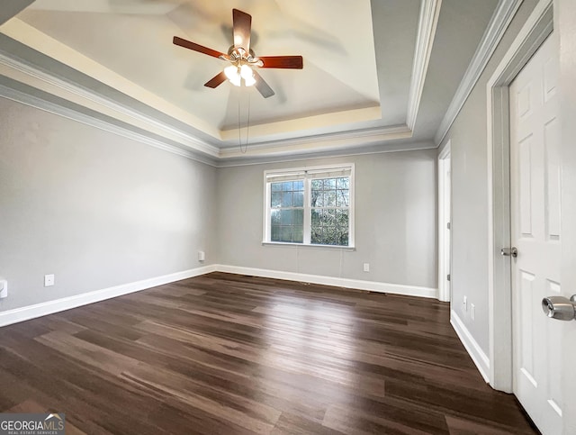 unfurnished bedroom with crown molding, baseboards, wood finished floors, a raised ceiling, and a ceiling fan