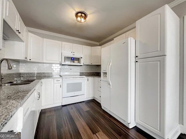 kitchen with a sink, light stone counters, white appliances, decorative backsplash, and dark wood-style flooring