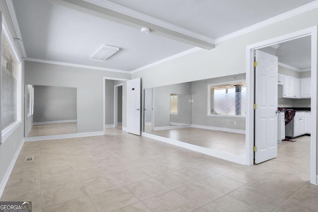 unfurnished room featuring light tile patterned floors, visible vents, baseboards, and crown molding