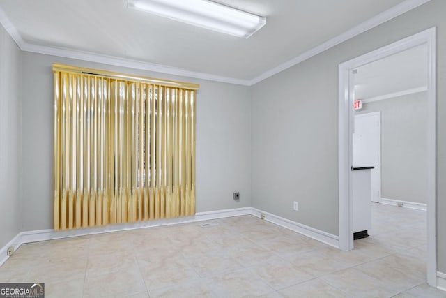 tiled spare room with crown molding and baseboards