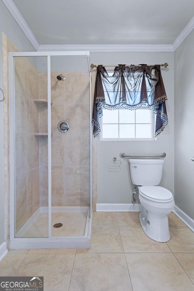 bathroom with a stall shower, toilet, and crown molding