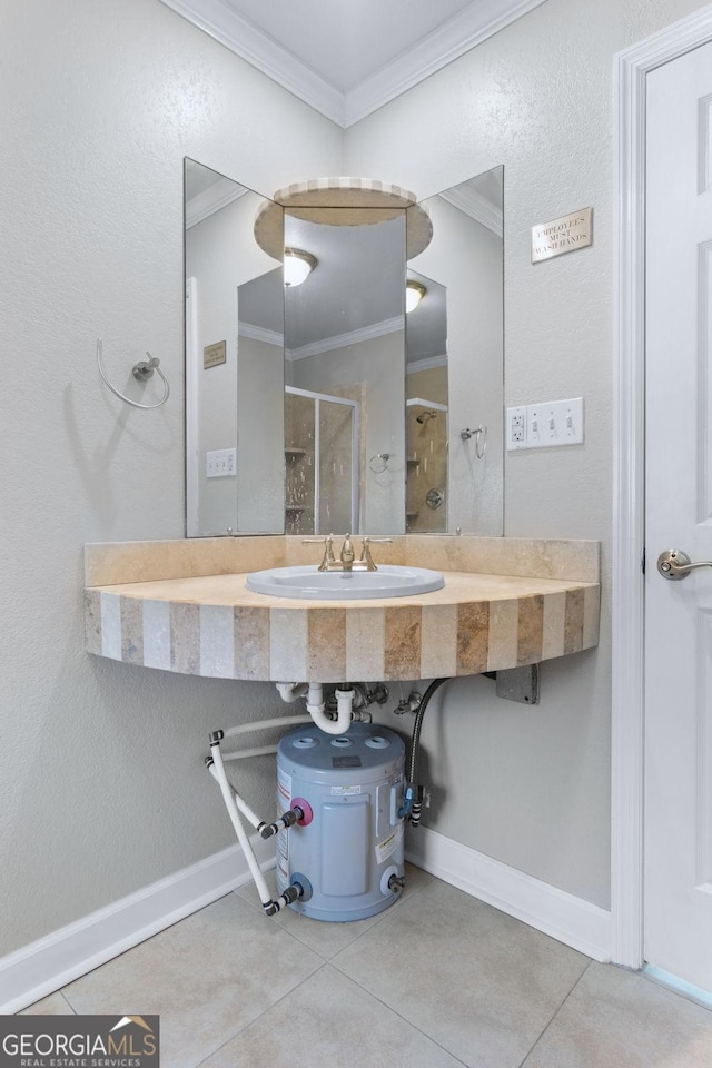 full bath featuring baseboards, ornamental molding, a stall shower, tile patterned floors, and a sink