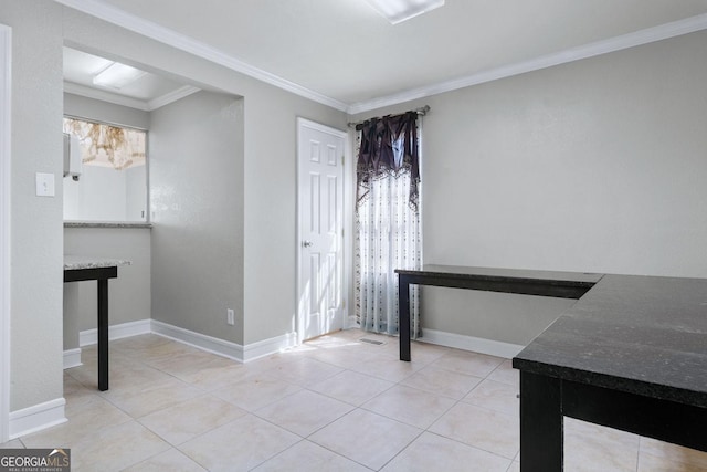 unfurnished dining area with crown molding, light tile patterned floors, and baseboards