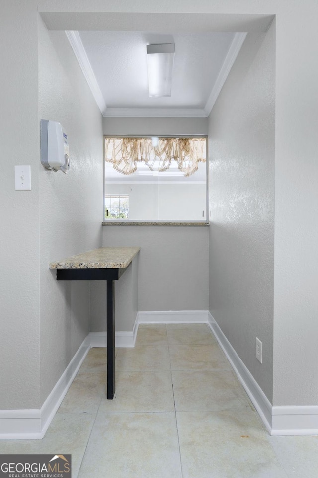 laundry room with baseboards and ornamental molding