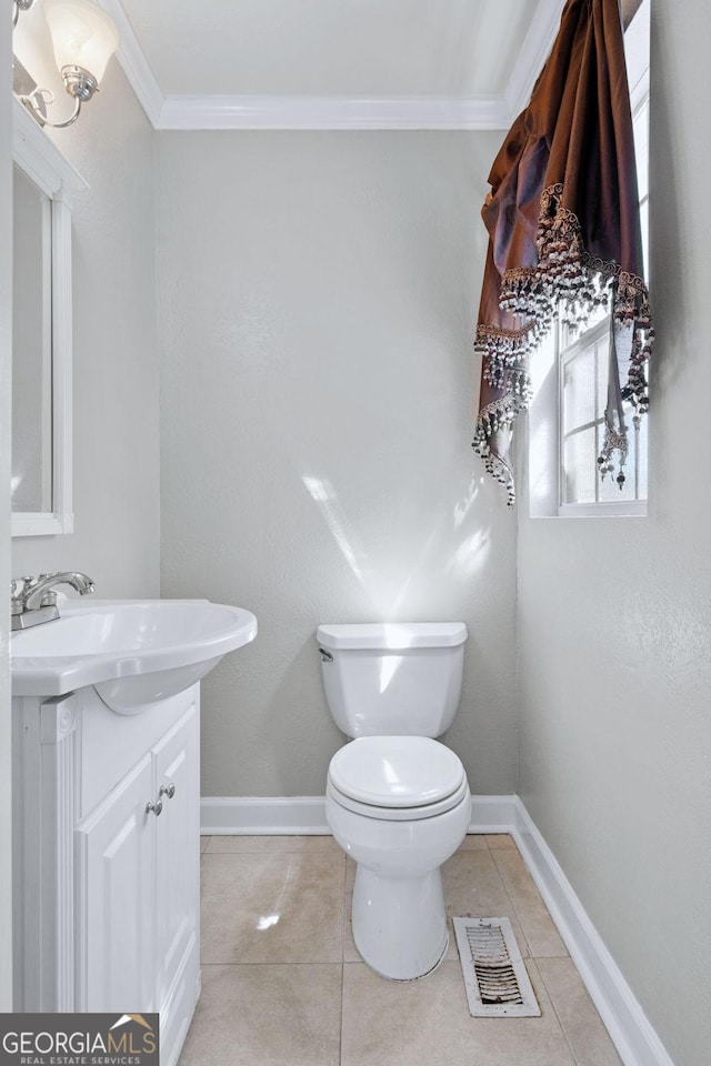 half bathroom with visible vents, baseboards, toilet, ornamental molding, and vanity