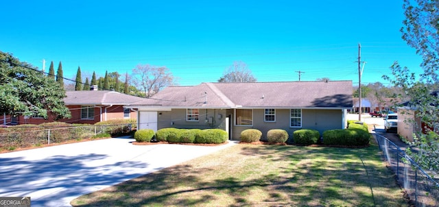 single story home with concrete driveway, a front yard, and fence