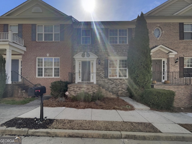 townhome / multi-family property featuring brick siding