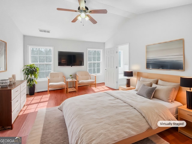 bedroom with visible vents, ceiling fan, lofted ceiling, and wood finished floors