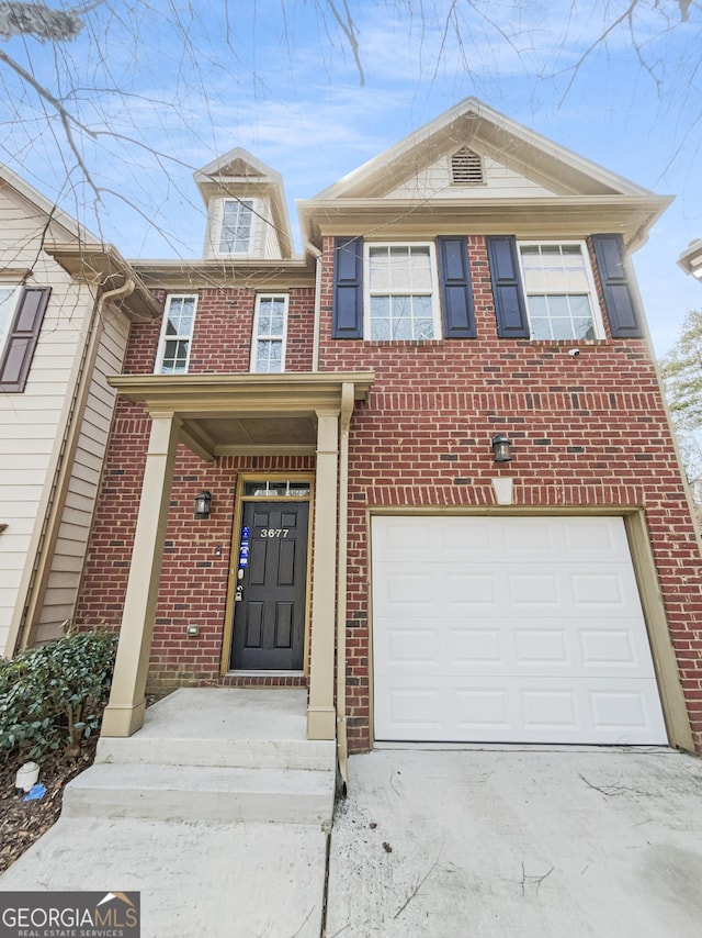 view of front facade with a garage, brick siding, and driveway