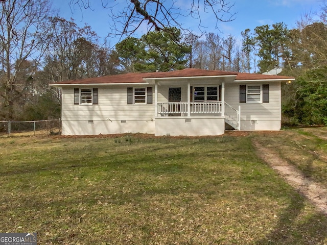 view of front of house featuring a front lawn, fence, covered porch, and crawl space