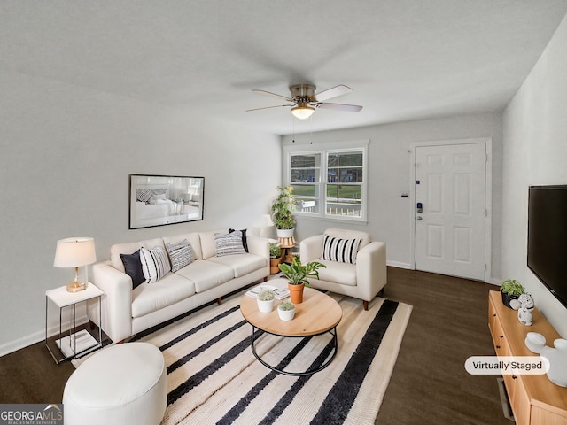 living room featuring baseboards, wood finished floors, and a ceiling fan