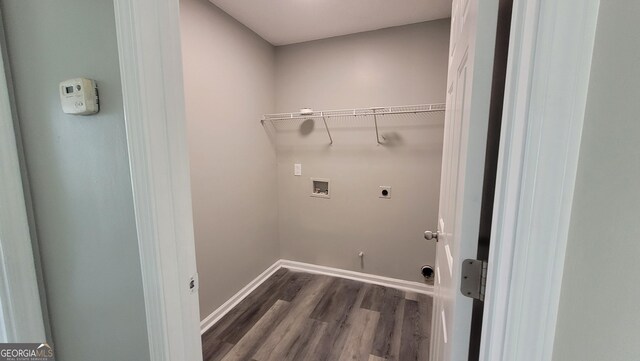 laundry area featuring electric dryer hookup, wood finished floors, baseboards, hookup for a washing machine, and laundry area