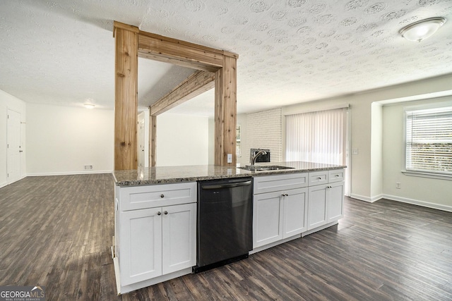 kitchen with dishwasher, dark stone countertops, dark wood-style flooring, and a sink