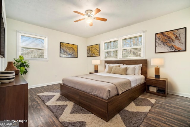 bedroom featuring a ceiling fan, baseboards, and dark wood-style flooring