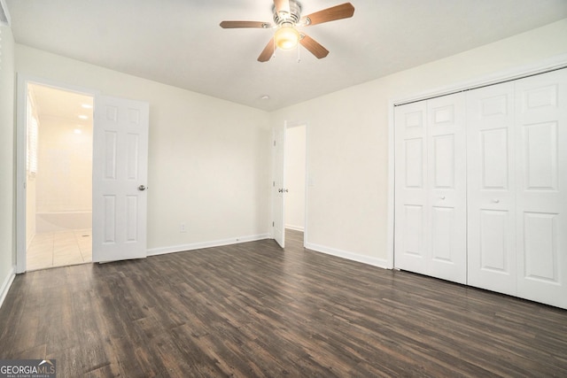 unfurnished bedroom featuring a closet, ceiling fan, dark wood-type flooring, and baseboards