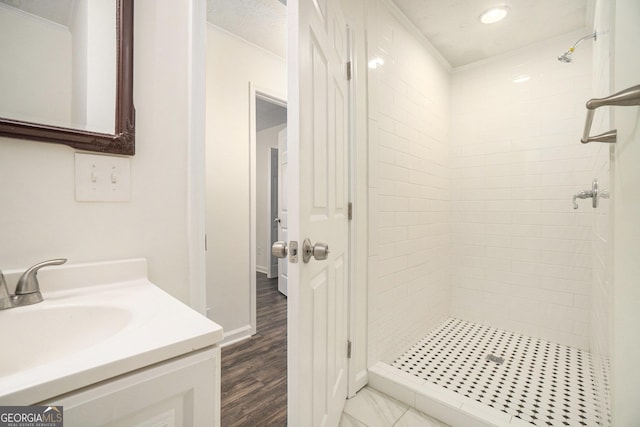 bathroom with vanity, ornamental molding, and a shower stall