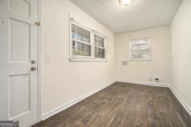 washroom featuring hookup for a washing machine, dark wood-style floors, baseboards, and laundry area