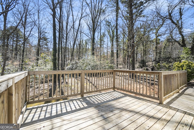 wooden deck featuring a wooded view