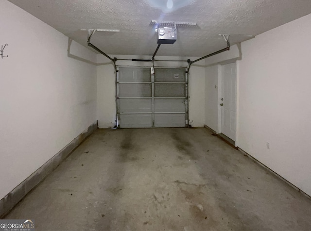 garage featuring a garage door opener and baseboards