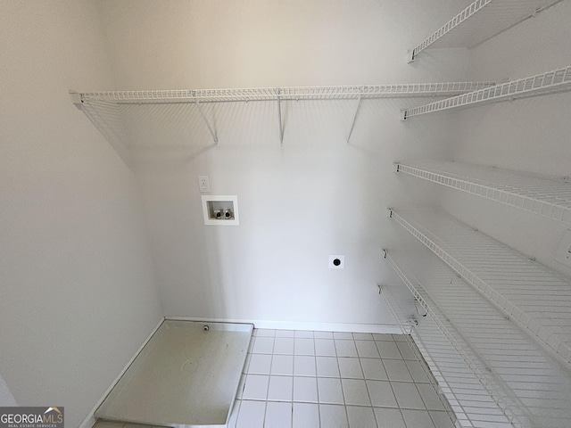 washroom with hookup for an electric dryer, washer hookup, laundry area, and tile patterned flooring