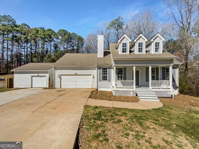 cape cod-style house featuring driveway, an attached garage, covered porch, a chimney, and a front lawn