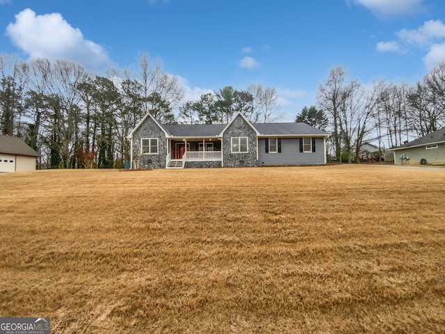 single story home with a front lawn, covered porch, and stone siding