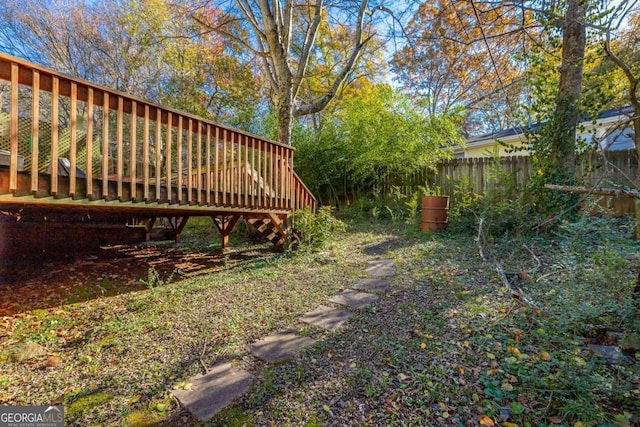 view of yard with a wooden deck and fence