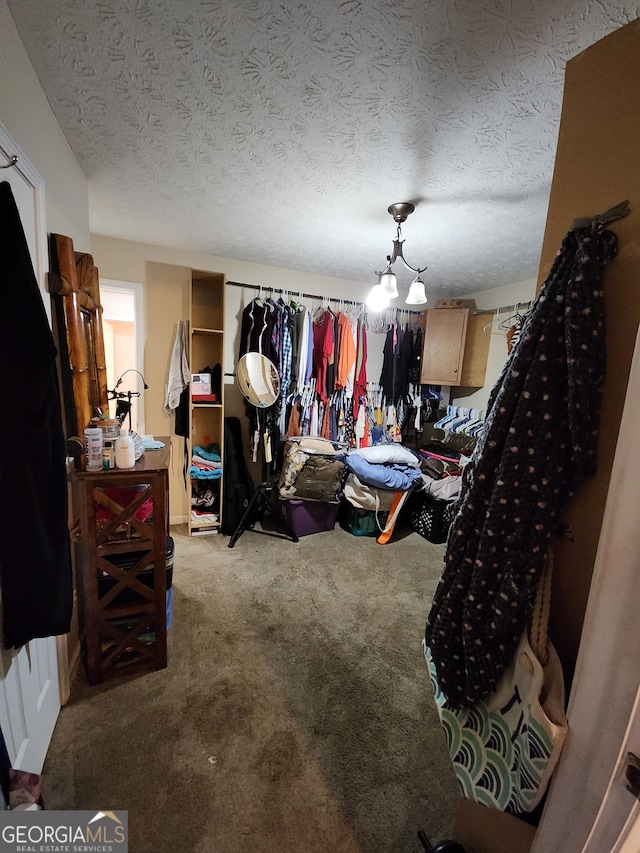 carpeted bedroom featuring a textured ceiling