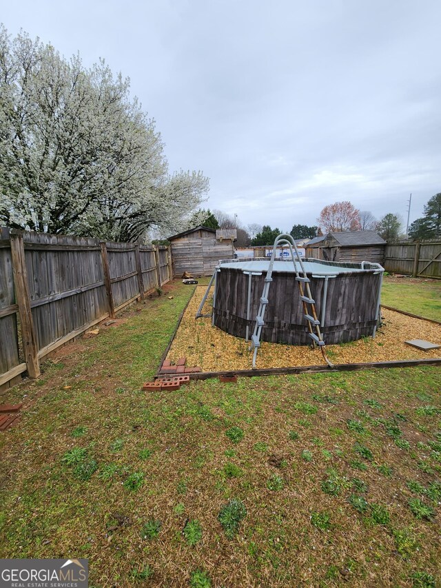 view of yard featuring a fenced in pool and a fenced backyard