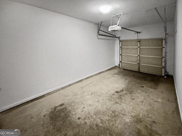 garage featuring baseboards and a garage door opener