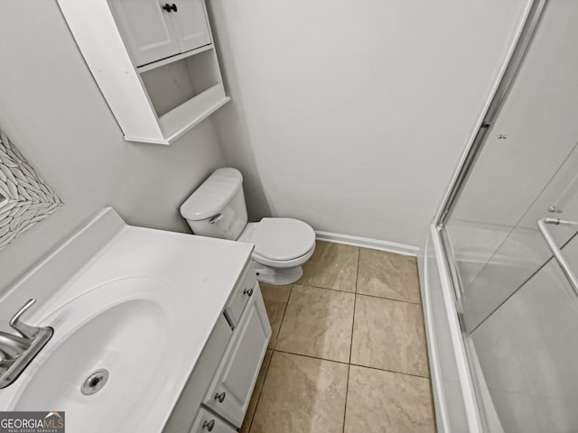 full bathroom with tile patterned flooring, baseboards, toilet, an enclosed shower, and vanity