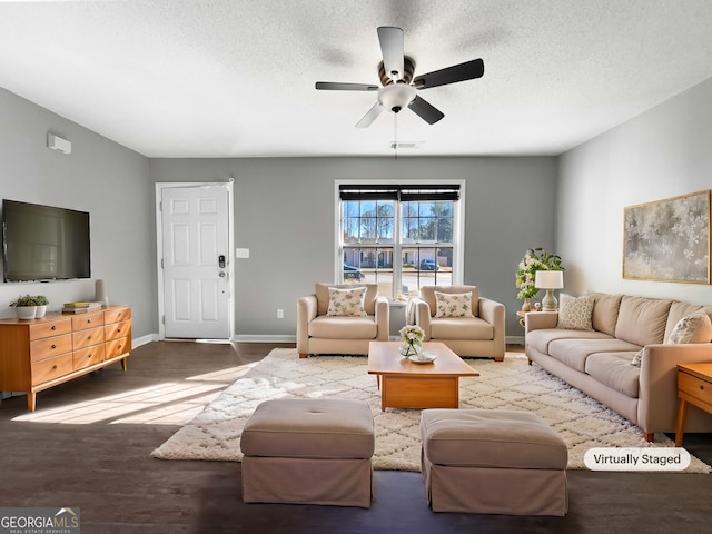 living room with visible vents, ceiling fan, baseboards, wood finished floors, and a textured ceiling