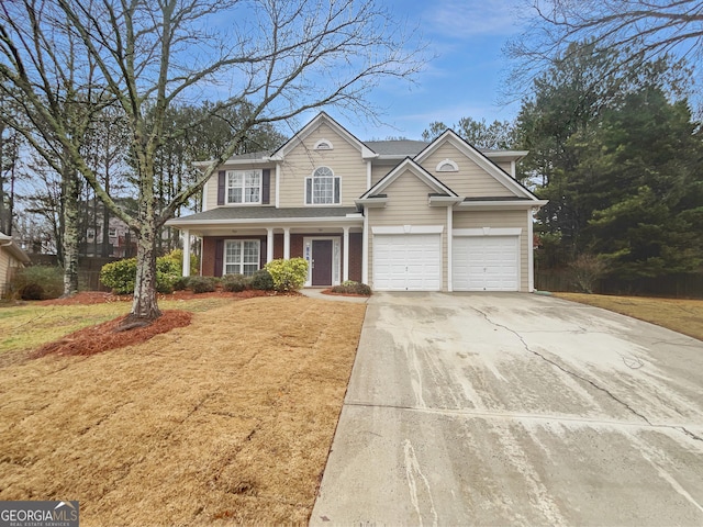 traditional-style house with brick siding, concrete driveway, and a front yard