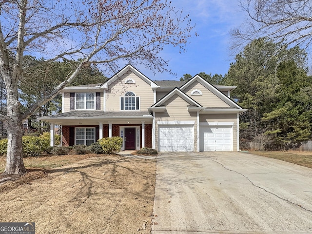 view of front of property featuring a garage, brick siding, and driveway