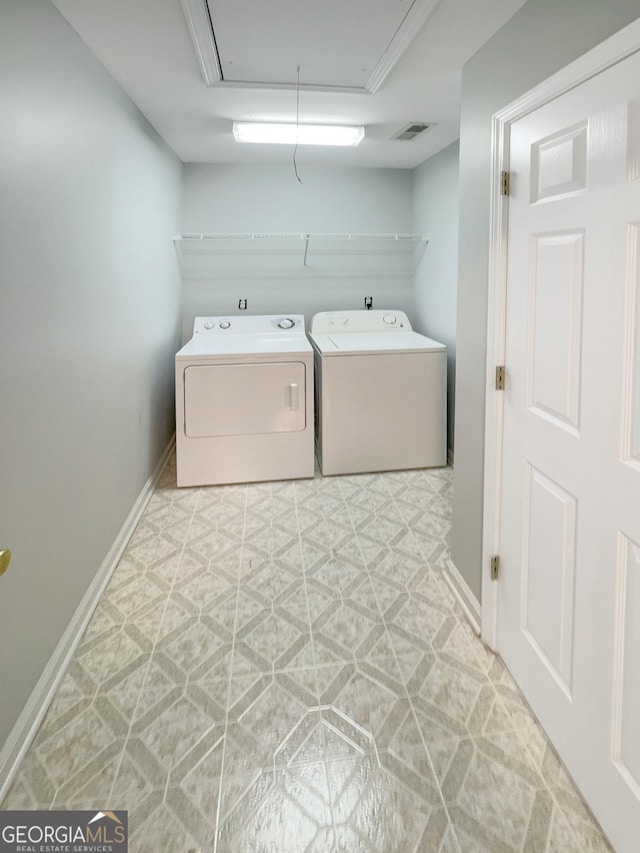 laundry room featuring independent washer and dryer, baseboards, light floors, attic access, and laundry area