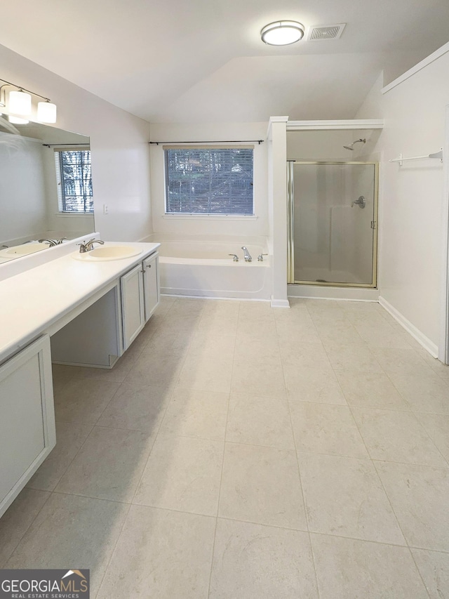 full bathroom with vanity, lofted ceiling, a stall shower, tile patterned floors, and a bath