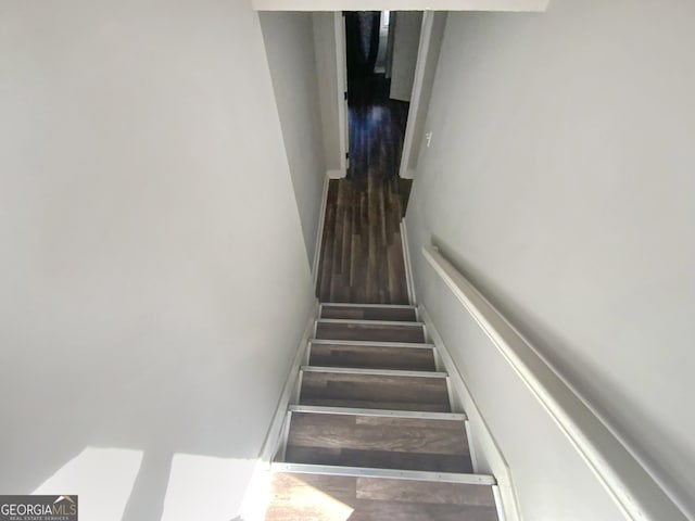 stairway with wood finished floors