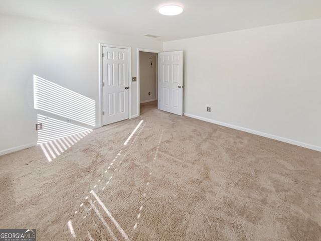 empty room featuring carpet flooring and baseboards