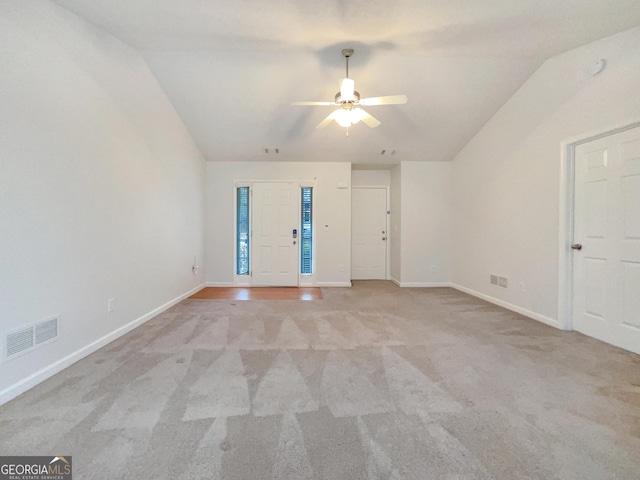 empty room featuring visible vents, light carpet, a ceiling fan, baseboards, and vaulted ceiling