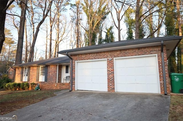 garage featuring concrete driveway