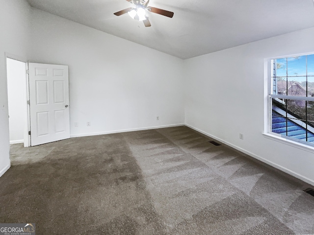 unfurnished room with lofted ceiling, carpet, baseboards, and ceiling fan