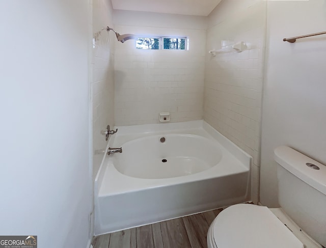 bathroom with toilet, shower / bathtub combination, and wood finished floors